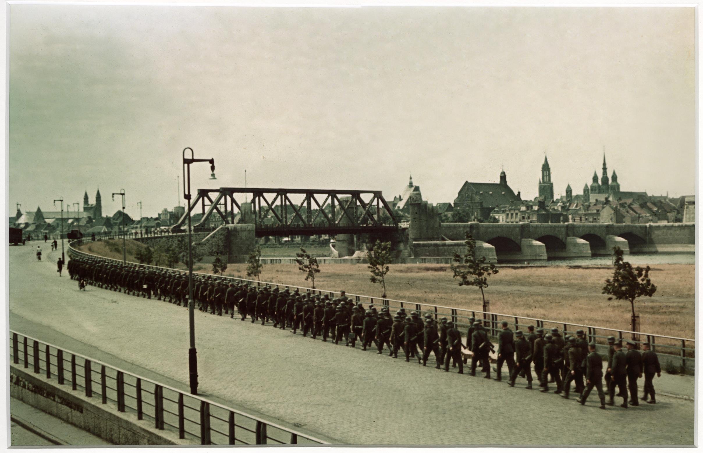 Marcherende Duitse kolonne op oostelijke Maasoever bij de Wilhelminabrug in Maastricht, augustus 1941